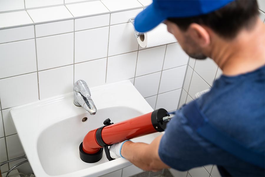 Plumber cleaning drains